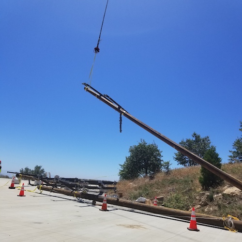 Utility infrastructure pole installation at an active field project